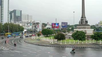 view of Victory Monument one of the central transport hubs landmark in Bangkok with smog smoke pollution environment video