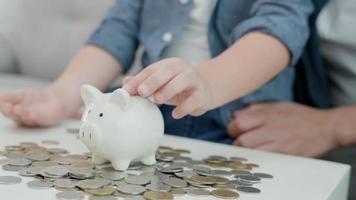 Save money. children putting coin into piggy bank for saving. wealth, Finance, insurance, investment, education, future, plan life, learn, banking, family, health, health and accident insurance. video