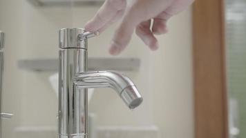 Save water. Volunteer keeps turning off the running water in the bathroom to protect environment. Greening planet, reduce global warming, Save world, life, future, risk energy, crisis , water day. video