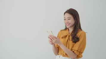 Asian beautiful woman exited surprise face expression . female feels shocked with the phone. exciting smile and happy adorable rejoices. Very enjoy and fun relax time. wow, girl holding smartphone.
