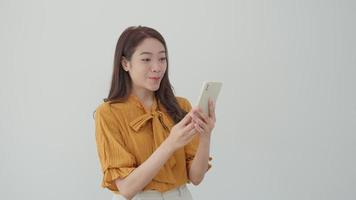 Asian beautiful woman exited surprise face expression . female feels shocked with the phone. exciting smile and happy adorable rejoices. Very enjoy and fun relax time. wow, girl holding smartphone. video