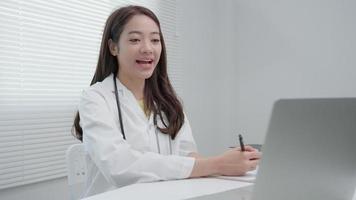 télé-médical. le médecin explique le médicament au patient par vidéoconférence. un médecin asiatique traite des patients par télécommunication tout en décrivant la maladie. technologie pour la santé. video