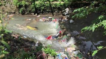 polluted river due to garbage and plastic. unhealthy for the environment. video