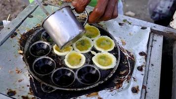 The finished raw material for fried eggs is usually called SD snacks in Indonesia which is then poured into a baked mold so that it is round and fits the mold. video