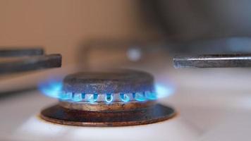 Burning natural gas in a gas stove in the kitchen. Video 4k in real time. Energy crisis, environmental problems and natural resources. Gas crisis with big gas bills.