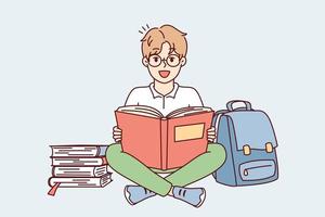 Positive schoolboy sits cross-legged on floor near backpack and stacks of textbooks getting ready for lessons. Delighted boy in glasses looks at camera while reading literature. Flat vector design