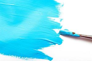 brush with blue color and Abstract acrylic blue painted spot background. Fluid art texture photo