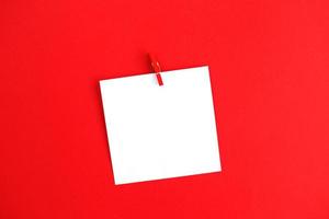 sticker with empty mockup for your text hanging on the pin on red background. Copy space for text photo