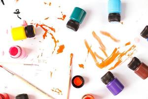 multicolored acrylic paints on a table with brushes. DIY photo