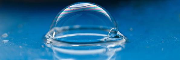 soap bubble close up. abstract blue water background photo
