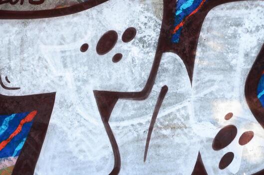 Close-up fragment of a graffiti drawing applied to the wall by aerosol paint. Background image of a modern composition of lines and colored areas. Street art concept photo