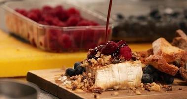 Dripping Raspberry Sauce Over Bread With Mixed Berries And Nuts. Dessert. - Close up shot video