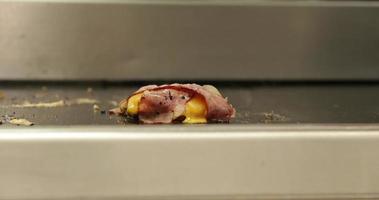 Grilling Hamburger Patty With Melted Cheese And Bacons Sizzling On A Stainless Griller. - close up shot video