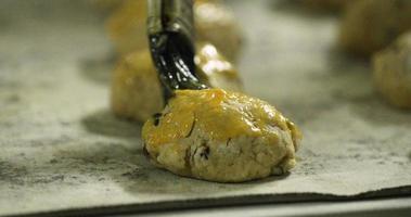 Brushing Cookie Dough With Beaten Egg Before Baking - slow motion video