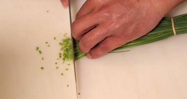 Chef Chopping Green Chives For Sushi At The Kitchen - overhead slowmo shot video