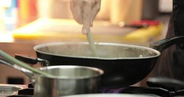 Chef Stirred The Creamy Sauce For Pasta In A Sauce Pan.- close up shot video