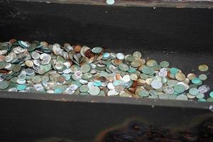 many dime coin dollar money on liberty island ferry pier wharf new york photo