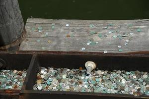 many dime coin dollar money on liberty island ferry pier wharf new york photo