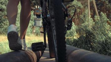 girl carries the bike through the dangerous bridge video