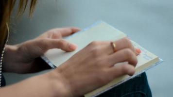 a young girl leads on Notepad and reads records close up video