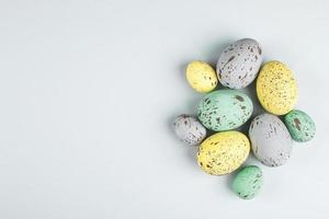 Easter eggs painted in pastel colors on grey background. Spring holiday concept. Flat lay, top view, copy space photo