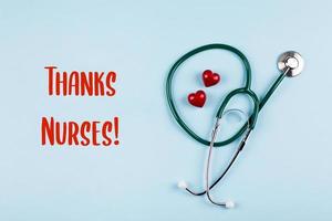 Thanks Nurses Card. Medical stethoscope, two red hearts. Healthcare medicine concept. photo