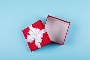 Open red gift box on background. Top view, flat lay, place for object. Mockup, holiday concept. photo