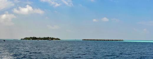 maldives on water bungalow resort view from ocean photo