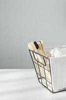 Eco natural tothbrush and cotton towel in metal basket. Zero waste concept. Plastic free. Copy space photo