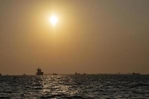 ship outside male harbor at sunset photo