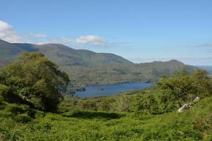 Scenic view over mountains and lake on sunny day photo