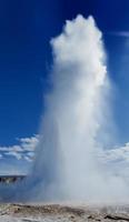 Geyser blow in Iceland while blowing water photo