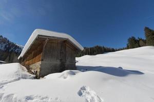 Old wood cabin house in the soft snow background photo