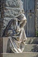 Widow marble statue outside a tomb photo