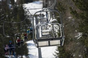 Chair Lift for skiers in winter snow time photo