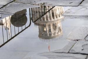 pisa dome and leaning tower close up detail view reflection in a puddle photo