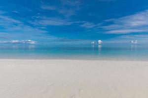 Blue sky over sea or ocean water surface. Idyllic sea and sky template. Tropical beach landscape and seascape, inspirational, tranquil, and relaxing sea view. Horizon, clouds and soft waves photo