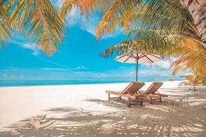 Vintage tranquil beach lounge chairs and umbrella. Summer holiday and vacation concept background. Inspirational tropical landscape design. Tourism and travel design, resort filter resort beach photo