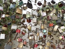 many love padlocks in graz bridge photo