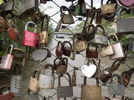 many love padlocks in graz bridge photo