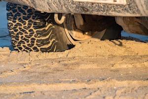 offroad car tire detail on sand beach photo