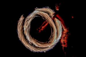 Fire dance Cook Islands polynesian dancer with pole of flames photo