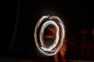 Cook Islands polynesian dancer flames isolated on black photo