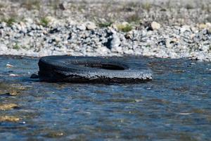 abandoned tire in a river photo