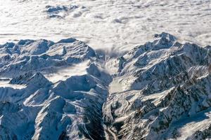 Alps mountains aerial view from airplane snow and avalanches photo