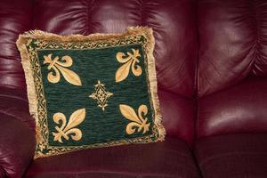 medieval fabric cuschion on leather sofa texture background photo