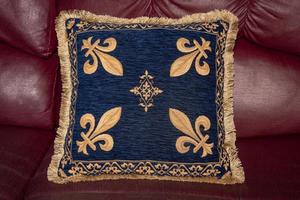 medieval fabric cuschion on leather sofa texture background photo