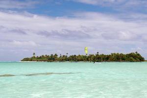 kite surfers on tropical polynesian beach aitutaki cook islands photo