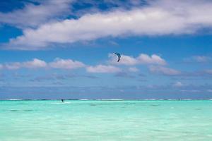 kite surfers on tropical polynesian beach aitutaki cook islands photo