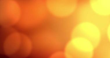 luxo de cores quentes com fundo de bokeh de brilho. movimento de círculos de bokeh vermelho e laranja. animação de loop contínuo video